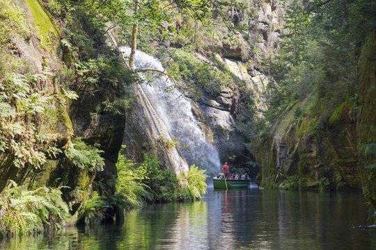 Boat at the waterfall in the Edmundsklamm, Kamenice River, Kamnitz, Hrensko, Herrnskretschen, Okres Dec&iacute;n, &Uacute;steck&yacute; kraj, Bohemian Switzerland, Elbe Sandstone Mountains, Czech Republic