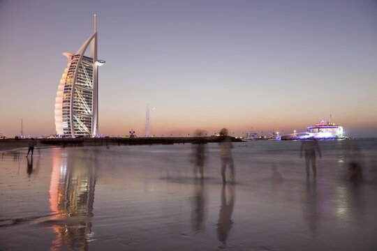 Luxury hotel Burj Al Arab and Jumeirah Beach at the blue hour, Dubai, Emirate of Dubai, United Arab Emirates