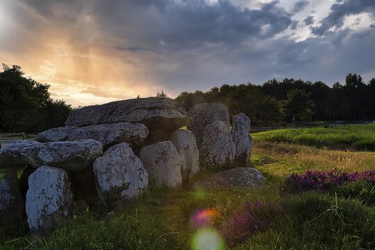Menhirs near Carnac, megalithic culture, sunset, backlight, coloured light reflections, Brittany, France