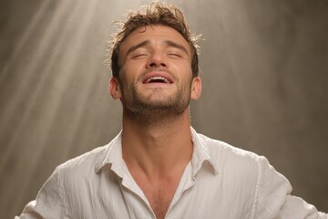 Fototapeta premium Spiritual Awakening And Emotional Release: Man With Eyes Closed Experiencing Divine Light And Inner Peace