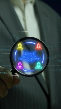 Business Relations concept, connections between stakeholders in the process of businesses. Businessman shows glowing neon line of Business Relations icon on magnifying glass.