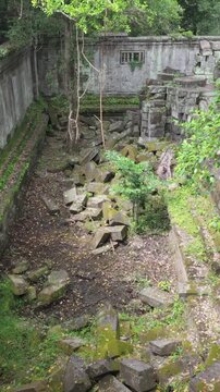 Beng Mealea temple ruins in Cambodia, overgrown with moss and jungle. The ancient stone structures are scattered and reclaimed by nature.