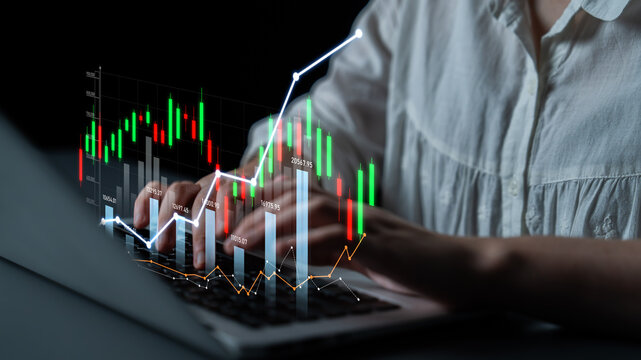 A business professional analyzes stock market graphs on a laptop, showcasing modern financial technology and investment growth concepts through detailed charts. Scalp