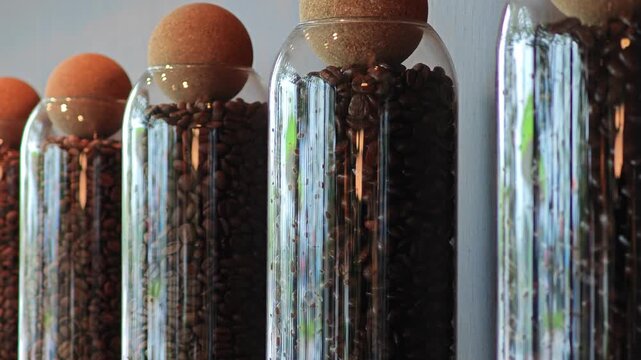 Roasted coffee beans in glass jar.
