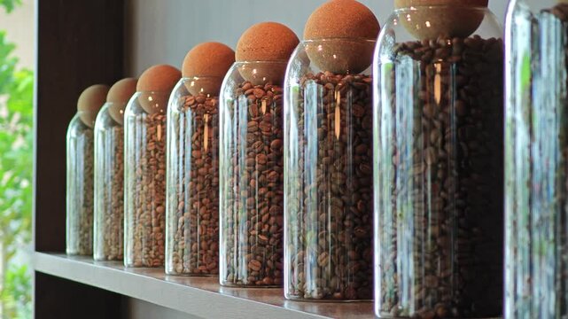 Roasted coffee beans in glass jar.