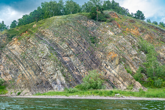 Steeply dipping sedimentary strata displaying evidence of Hercynian orogeny and tectonic compression in Lower Carboniferous rocks