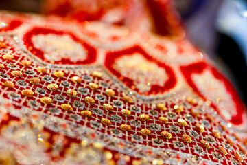 Fototapeta premium Indian bride's traditional outfit fabric and texture close up