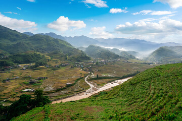 Breathtaking panoramic view of terraced rice fields and rural village in Sapa valley, Northern Vietnam © Kittiphan
