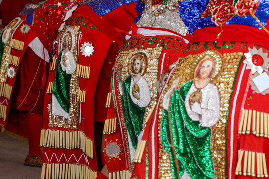 Religious imagery on red dance regalia detail