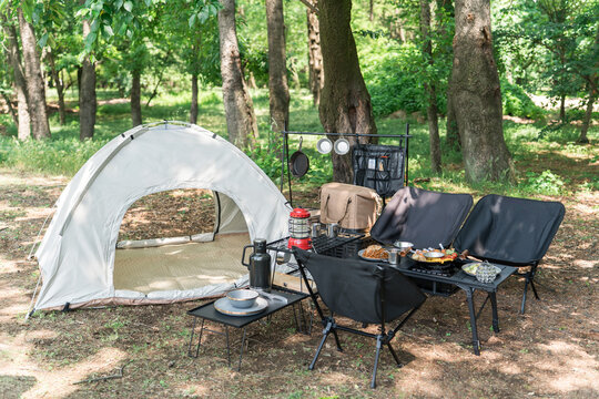 Camping equipment set up in a campground or park, campsite, day camp