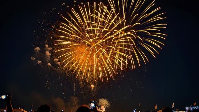 Spectacular golden fireworks lighting up the night sky during a festive outdoor celebration