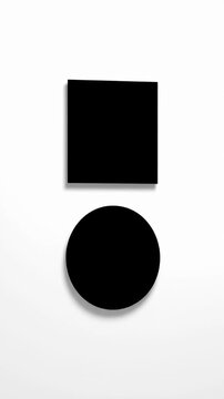Minimalist black square and circle on white surface.