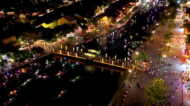 Panorama aerial drone view of Hoi An ancient town with boat tour and beautiful lanterns in night. UNESCO world heritage. One of the most travel popular touristic destinations