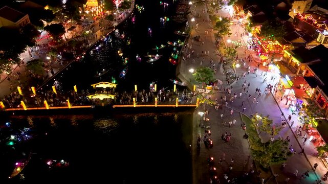 Panorama aerial drone view of Hoi An ancient town with boat tour and beautiful lanterns in night. UNESCO world heritage. One of the most travel popular touristic destinations