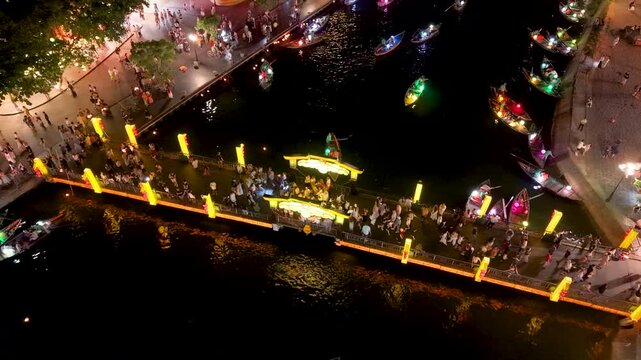 Panorama aerial drone view of Hoi An ancient town with boat tour and beautiful lanterns in night. UNESCO world heritage. One of the most travel popular touristic destinations