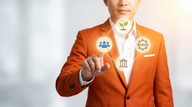 Businessman in orange blazer touching a glowing circular digital interface with e s g representing environmental social and governance factors in a blurred office setting