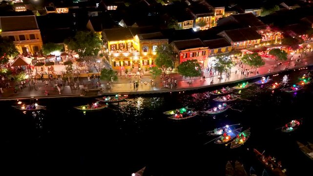 Panorama aerial drone view of Hoi An ancient town with boat tour and beautiful lanterns in night. UNESCO world heritage. One of the most travel popular touristic destinations