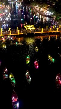 Panorama aerial drone view of Hoi An ancient town with boat tour and beautiful lanterns in night. UNESCO world heritage. One of the most travel popular touristic destinations