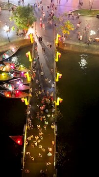 Panorama aerial drone view of Hoi An ancient town with boat tour and beautiful lanterns in night. UNESCO world heritage. One of the most travel popular touristic destinations