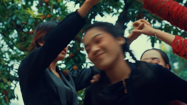 Smiling Girls Passing Under Friends Arms