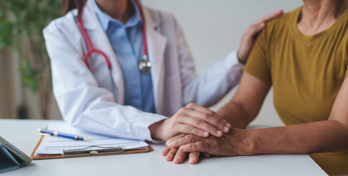 Doctor comforting senior patient offering empathy and support