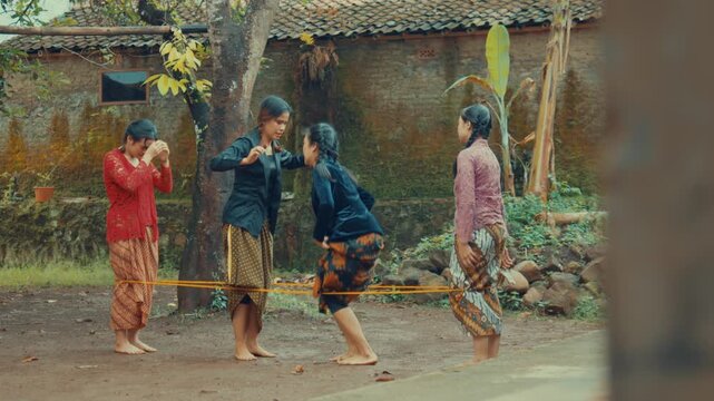 Four Women Playing High Level Rubber Rope Game