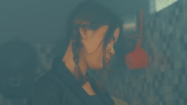 Side Profile of Sad Girl with Braids in Kitchen
