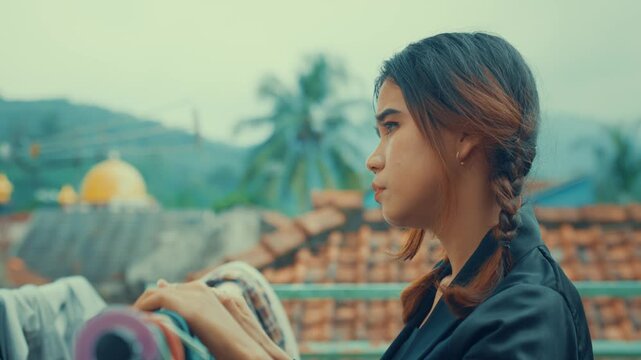 Side Profile of Asian Woman Doing Laundry Chores