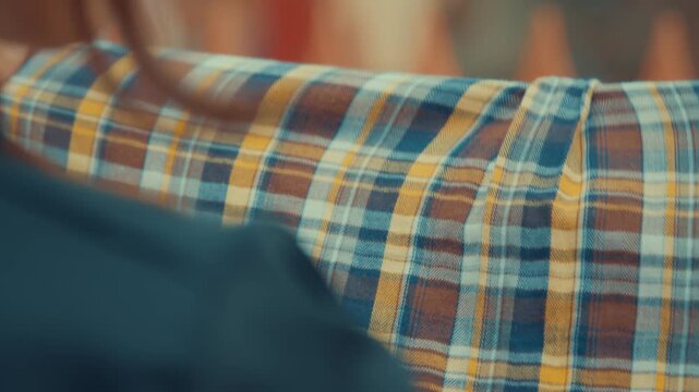 Woman's Hands Hanging Plaid Shirt on Drying Rack