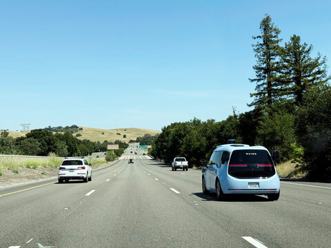Waymo autonomous Zeekr robotaxi traveling on California Highway 280 with surrounding traffic - California, USA - May 25, 2026