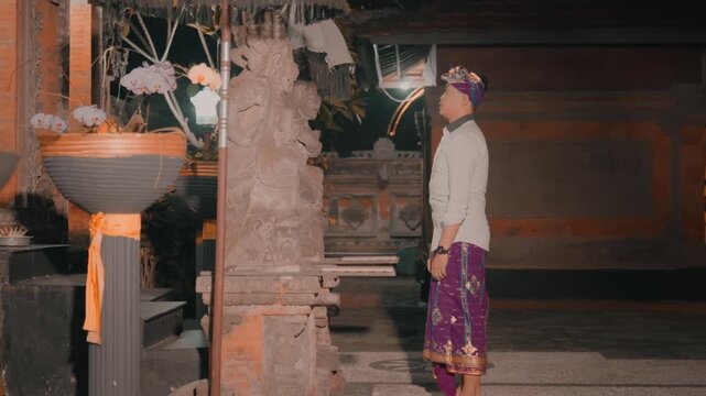 Man Standing in Profile Observing Hindu Shrine