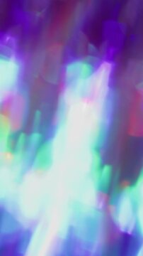 Vertical video. Prism bokeh lens. Leak illumination. Neon color fractal shimmering kaleidoscope rotation. Purple red green abstract blur background.