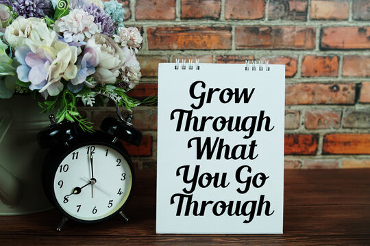 Grow Through What You Go Through  Motivational And Inspirational Quotes on wooden background