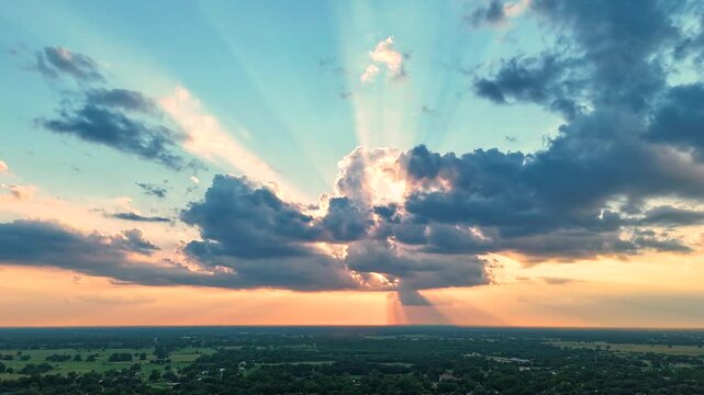 Dramatic Aerial Sunset with Backlit Clouds and Sunbeams