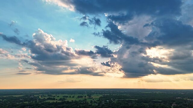 Aerial Sunset with Sun Rays Breaking Through Dramatic Clouds