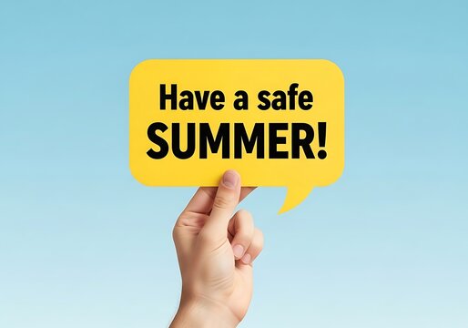 Hand holding a yellow speech bubble with the text have a safe summer