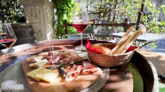 Italian Red Wine and Charcuterie Board at an Outdoor Cafe in Piedmont