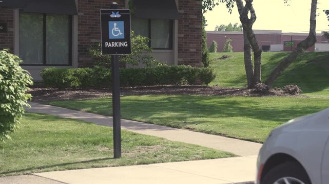 Handicap Accessible Parking Sign Post Near Brick Building