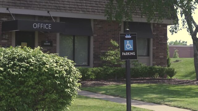 Office Building with Blue Accessible Parking Sign Post