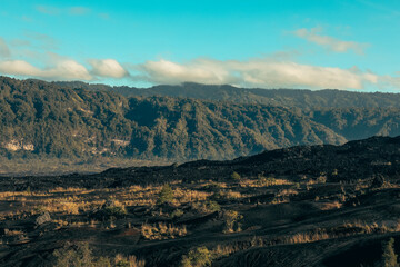 Fototapeta premium Volcanic landscape with green vegetation and hills