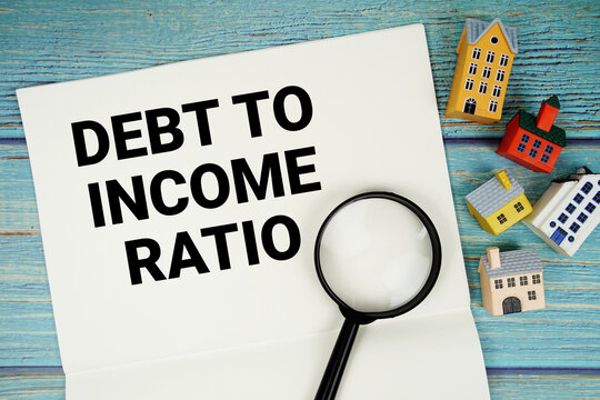 Notepad with "DTI Debt-to-income Ratio" with magnifying glass and house model on wooden background