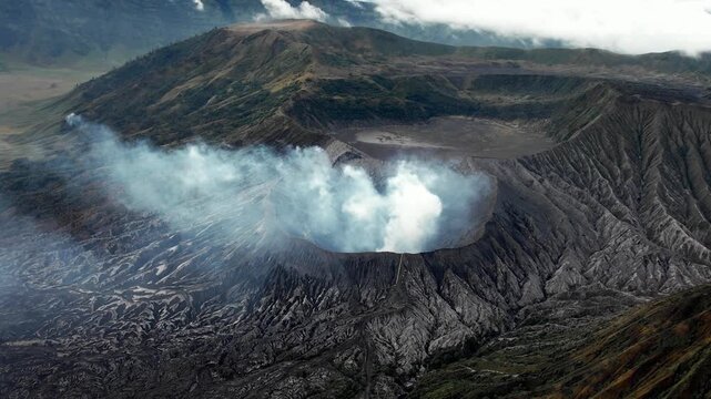 A plume of smoke rising from a volcano. Aerial photography of volcanic fissures and smoke emissions