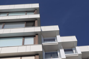 Modern Apartment Building Balconies Against Deep Blue Sky © matthew