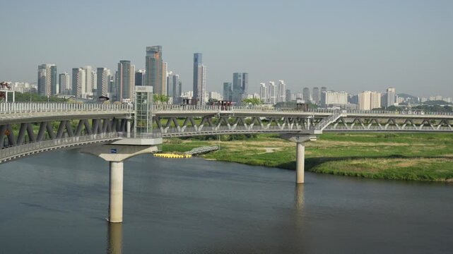 High Angle Wide Shot of Eungdari Geumgang Pedestrian Bridge and Sejong City Skyline, South Korea