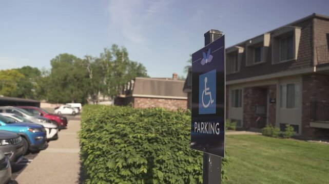 Accessible Handicap Parking Sign Near Building with Trees