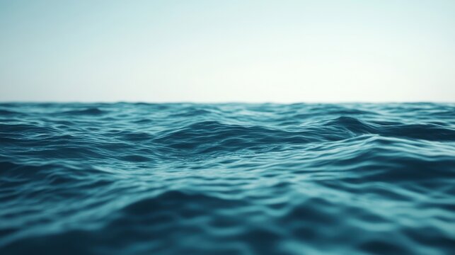 Rippling ocean water surface with gentle waves and soft horizon under a bright sky