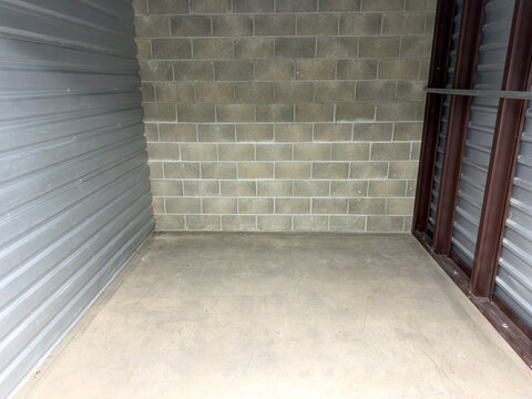 Empty Storage Unit With Concrete Floor And Cinderblock Wall