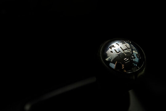 Gear shift lever of the car in the dark background