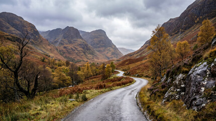 Obraz premium Scenic winding road through Glencoe's autumn landscape in Scotland