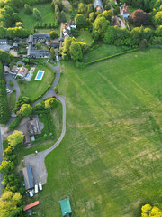 Obraz premium High Angle View of British Countryside and Landscape of Bedfordshire England UK. Drone Camera Footage Was Captured Medium High Altitude During Bright Sunny Day With Blue Sky and Hot Summer Day Over UK